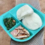 Lunch of maize porridge, fish and greens