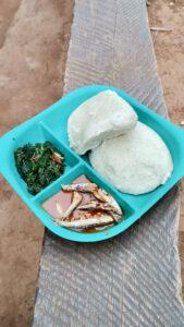Lunch of maize porridge, fish and greens