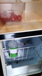 Fridge with tomatoes and water