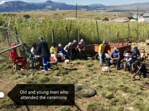 Group of men sitting outside