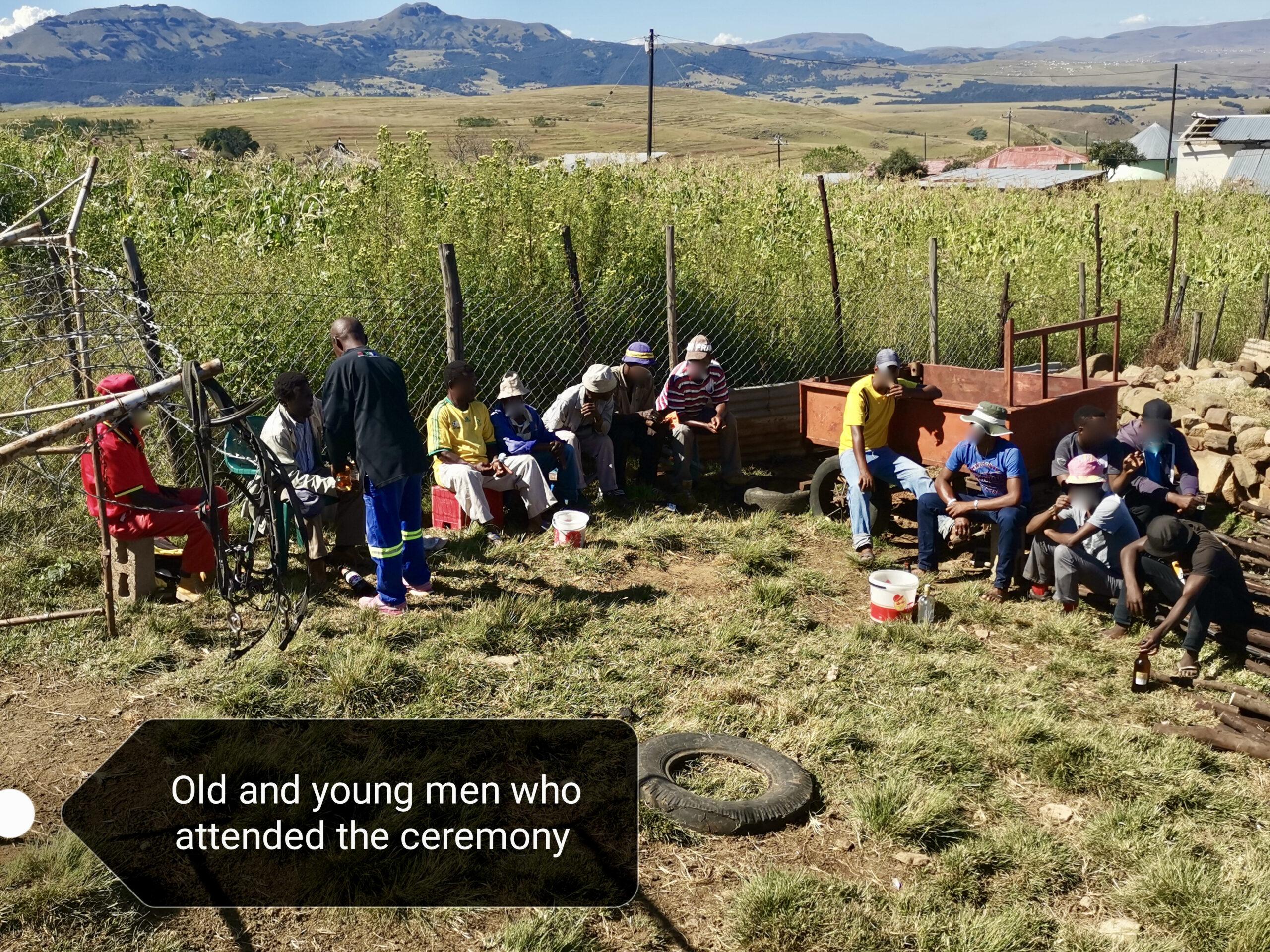 Group of men sitting outside