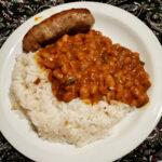 Dinner plate with rice, beans and beef sausage