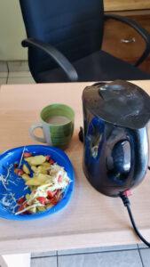 Kettle with cup of tea and