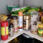 Pantry cupboard with spices, instant coffee, potato crisps