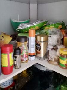 Pantry cupboard with spices, instant coffee, potato crisps