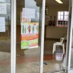 Mariannridge Clinic entrance with a “STOP TB poster” on left of the door and a “Sanitise your hands” poster on the right.