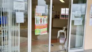 Mariannridge Clinic entrance with a “STOP TB poster” on left of the door and a “Sanitise your hands” poster on the right.