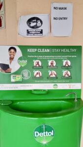 COVID-19 sanitising area within the clinic including “No mask, no entry” poster, “Wash and sanitise your hands” poster and “Keep clean, stay healthy” hand washing station sponsored by Dettol with correct handwashing illustration.