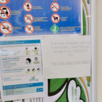 Clinic notice board with Prevention is Life poster, Sequence for putting on PPE poster and mother and child room poster.