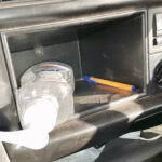 Hand sanitiser in glove compartment of car